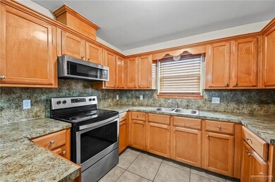 Kitchen featuring stainless steel appliances, sink, and backsplash