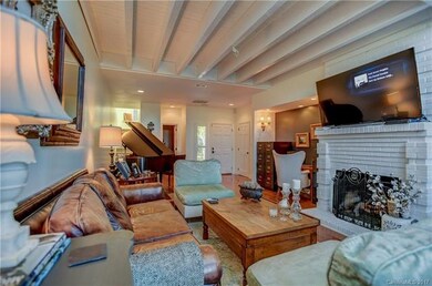 Open beam ceilings make this room feel large and s