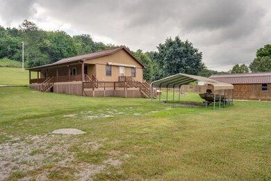 Two car carport and one of THREE outbuildings on the property!