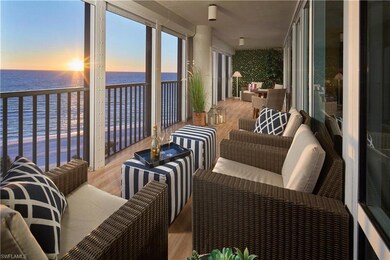 Sunroom with a beach view and a water view