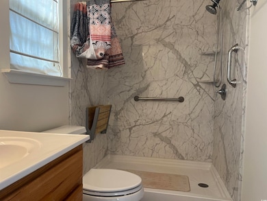 Full bathroom with vanity and a marble finish shower