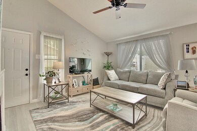 Living room featuring ceiling fan, wood-type floor