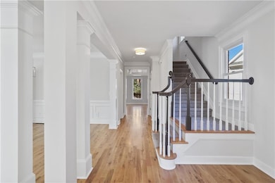 Hall featuring crown molding, a healthy amount of 