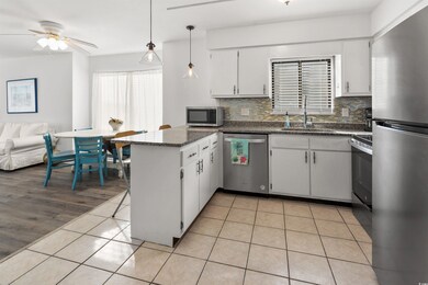 Kitchen with white cabinets, decorative backsplash
