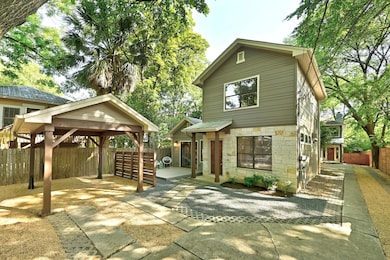 View of front of house featuring stone siding, a 