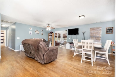Open Living Room and Dining Area with Access to the Sun room