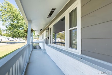 Covered porch with a sunroom