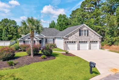 Traditional-style house with driveway, brick siding, and a shingled roof