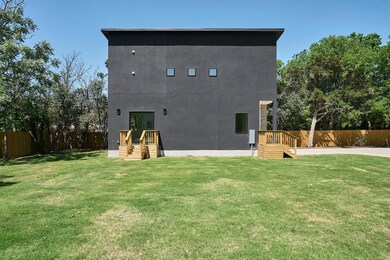 Rear view of property with fence and a lawn