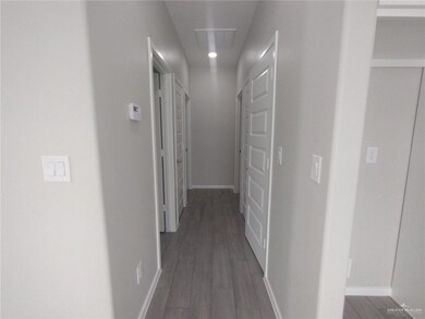 Hall with dark wood-type flooring