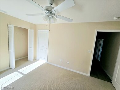 Unfurnished bedroom with light carpet, a closet, a