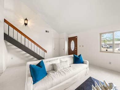 Vaulted ceilings, modern styled staircase in Living room