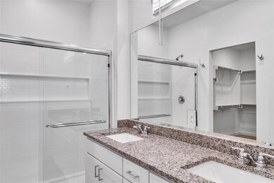 Bathroom featuring a stall shower, a walk in close
