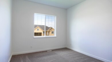 Carpeted empty room featuring baseboards