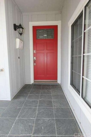 Entryway with custom front door and tile.