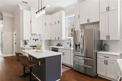 Large kitchen with quartz counter tops, floor to c