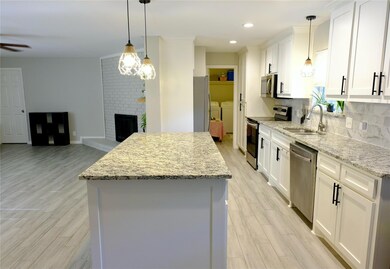 Laundry room is adjacent to remodeled kitchen.