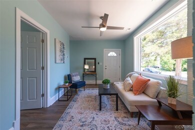 Living room featuring ceiling fan and hardwood / w