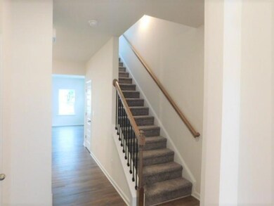 Stairs with wood finished floors and baseboards