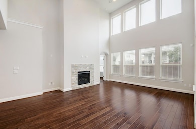 Unfurnished living room featuring a towering ceil