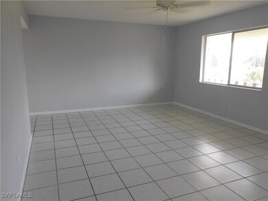 Unfurnished room with ceiling fan and baseboards