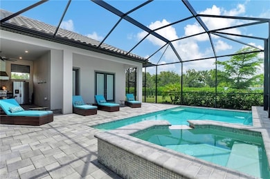 View of salt water pool and hot tub, ceiling fan, 