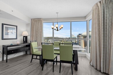 Dining area featuring an inviting chandelier, wood-type flooring, and a textured ceiling