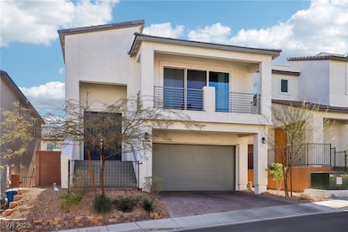 View of front of home with a garage, central AC, a