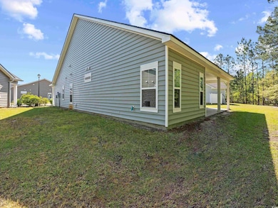 View of side of home with a lawn