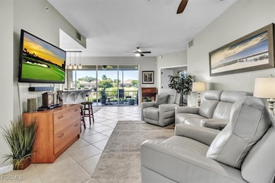Living room featuring light tile patterned flooring and a ceiling fan