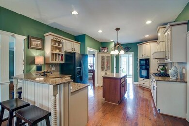 Kitchen has beautiful granite and upgraded cabinets. It has  updated gas burner stove top for gourmet cooks. Check out the island which as additional storage and a large pantry closet.