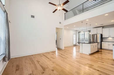 Kitchen featuring light wood finished floors, dar