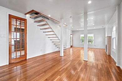 Unfurnished living room featuring wood-type floori
