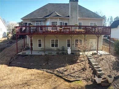 Rear view of property with a chimney, a deck, a sh