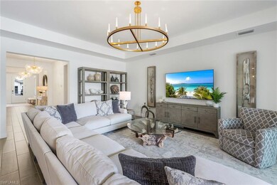 Living room with a notable chandelier and a tray c