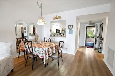 Dining room with wood finished floors and arched walkways