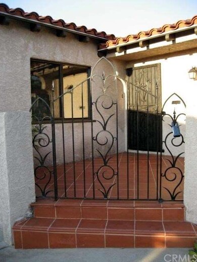 Front porch with decorative rod iron work.