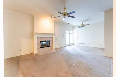 Unfurnished living room featuring ceiling fan, a t