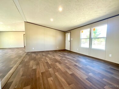 Unfurnished living room featuring vaulted ceiling,