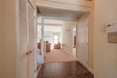 Entry way with family room ahead and kitchen on th
