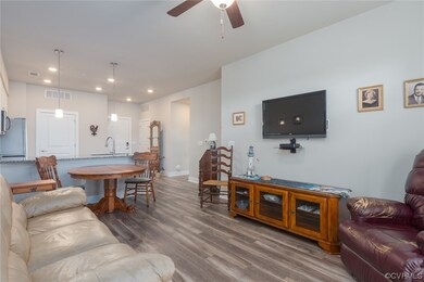 Hardwood floored living room with ceiling fan