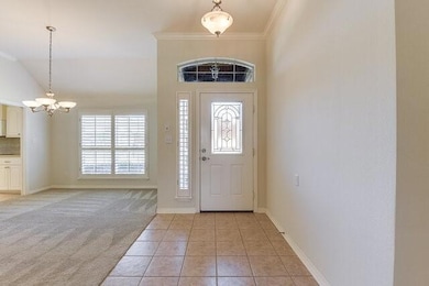 Foyer featuring a notable chandelier, ornamental m