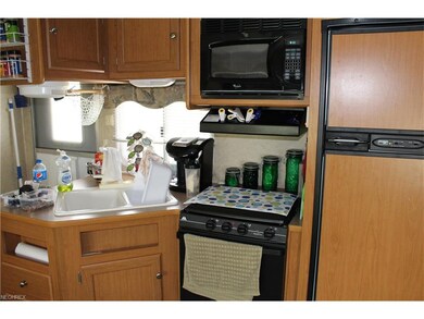 Kitchenette with oven, stove top, refrigerator, mi