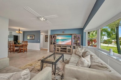 Living room featuring wainscoting and a chandelier