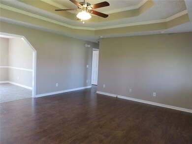 Another angle of the this great Living Room with new flooring, fresh paint, new fan and light fixture, and double trey ceilings