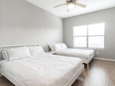 Bedroom with wood finished floors and ceiling fan