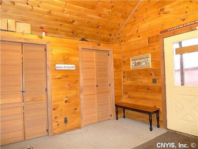 Foyer. Mudroom with cathedral ceiling and closet s