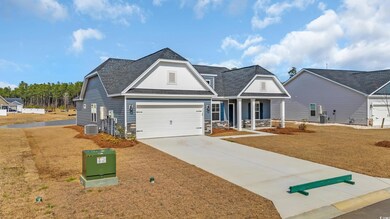 View of front of home featuring a garage, stone si