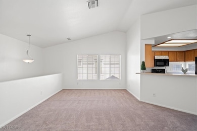 Unfurnished living room featuring lofted ceiling,