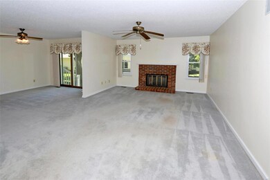 Gas fireplace place, ceiling fan and 2 windows ove